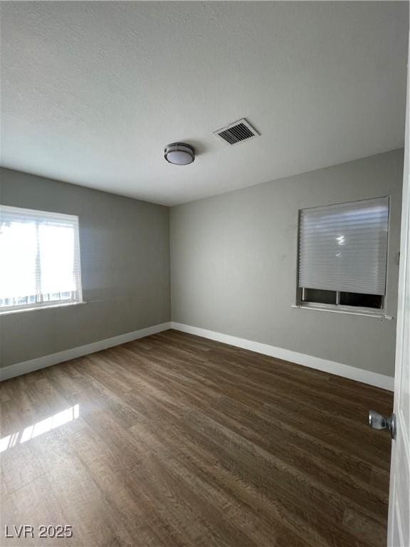 spare room featuring dark hardwood / wood-style flooring