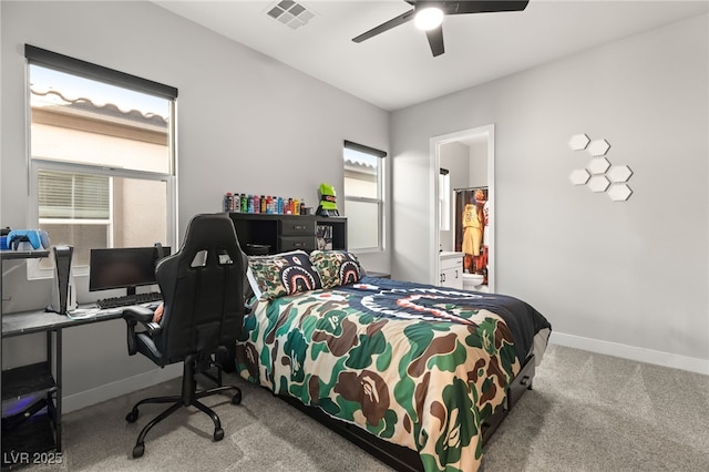 bedroom featuring ensuite bath, light colored carpet, and ceiling fan