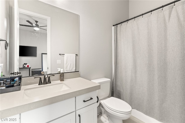 bathroom featuring vanity, ceiling fan, and toilet