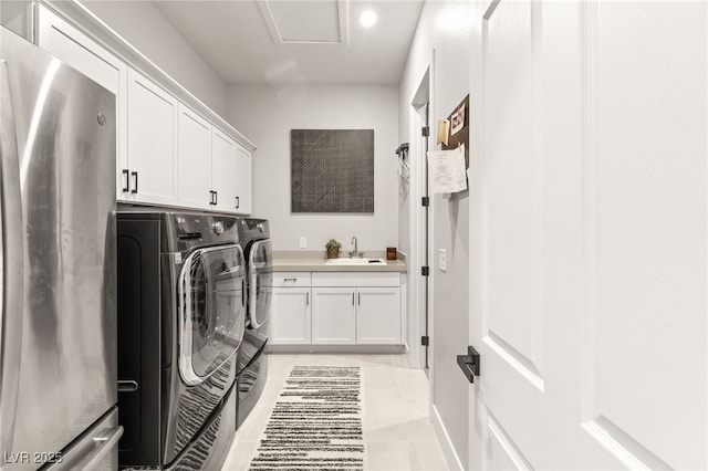 laundry room with cabinets, separate washer and dryer, and sink