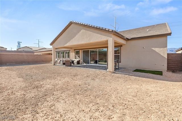 rear view of property with a patio area