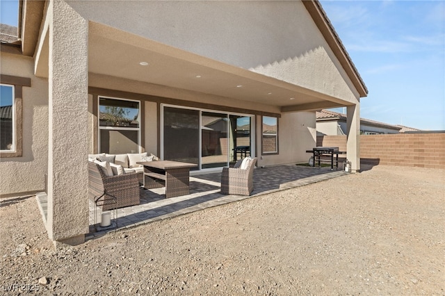 back of property with an outdoor hangout area and a patio