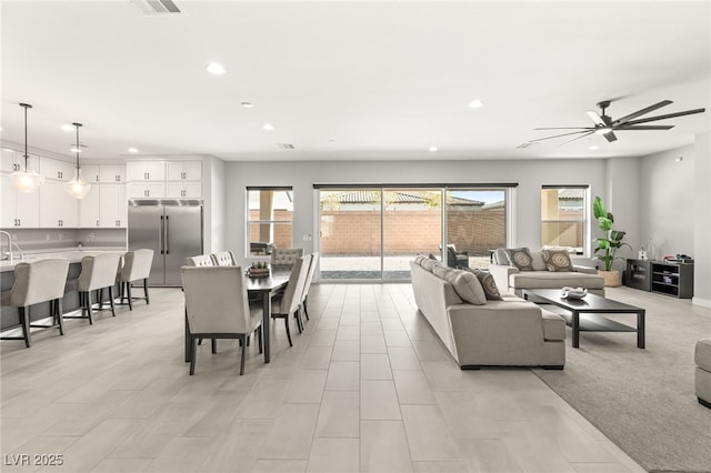 living room with sink and ceiling fan