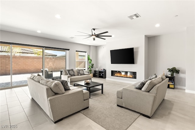 tiled living room featuring ceiling fan