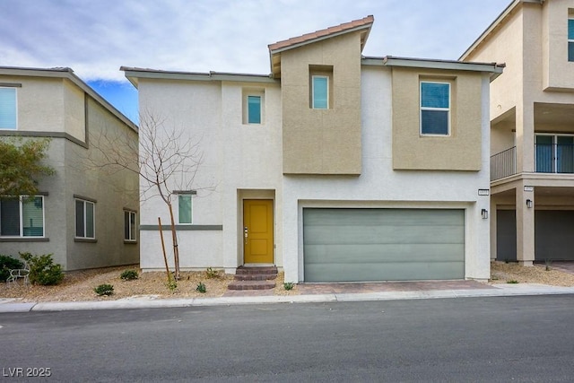 townhome / multi-family property featuring stucco siding and a garage