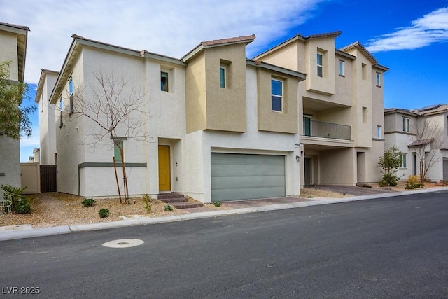 multi unit property with an attached garage and stucco siding