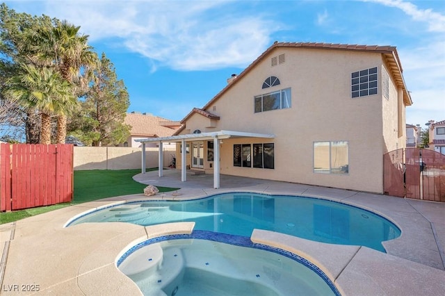 view of swimming pool with a patio, a gate, a fenced backyard, and a pool with connected hot tub