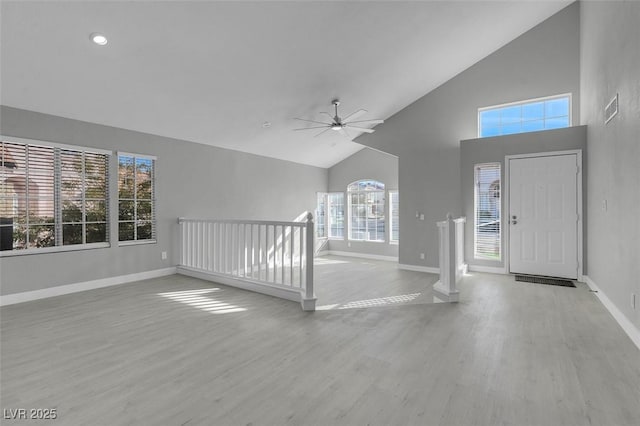 entrance foyer featuring high vaulted ceiling, ceiling fan, baseboards, and wood finished floors