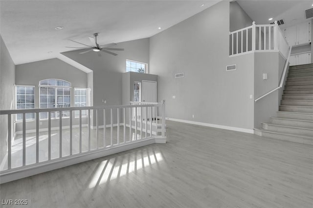 unfurnished living room featuring ceiling fan, wood finished floors, visible vents, and baseboards