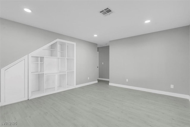 interior space with recessed lighting, visible vents, baseboards, and wood finished floors