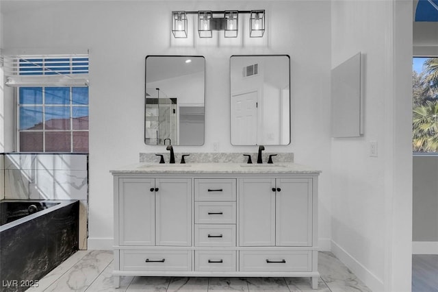 full bathroom with marble finish floor, visible vents, a sink, and baseboards