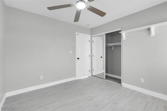 unfurnished bedroom with a closet, ceiling fan, baseboards, and wood finished floors