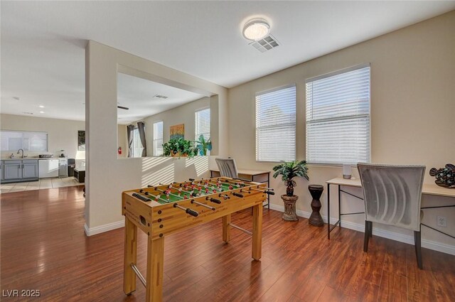 playroom with dark hardwood / wood-style floors and sink