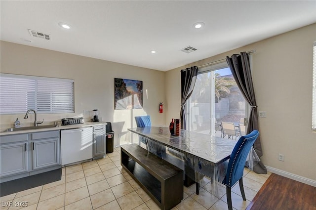 dining space featuring sink and light tile patterned floors