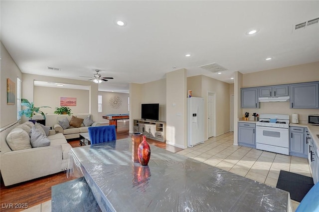 interior space featuring ceiling fan and light tile patterned floors