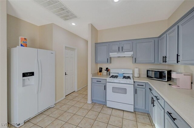 kitchen featuring white appliances and light tile patterned floors