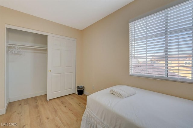 bedroom featuring light hardwood / wood-style floors and a closet