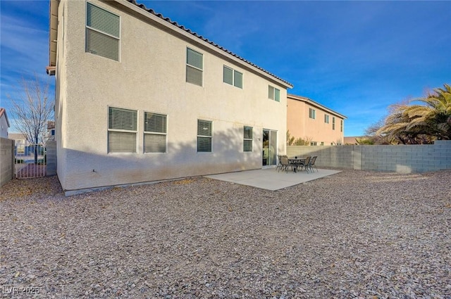 rear view of property featuring a patio area