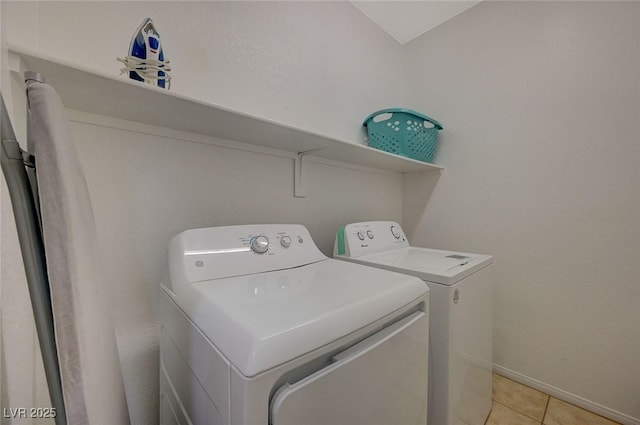 laundry area with light tile patterned flooring and washing machine and clothes dryer