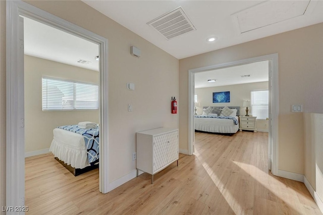 hallway with a wealth of natural light and light wood-type flooring