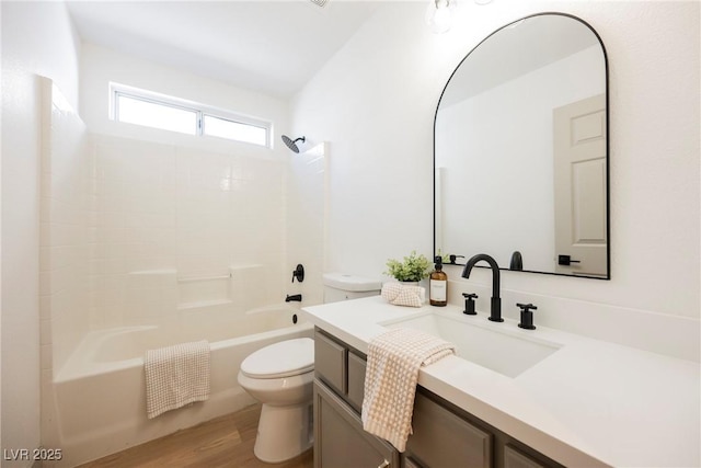 full bathroom with hardwood / wood-style flooring,  shower combination, toilet, and vanity