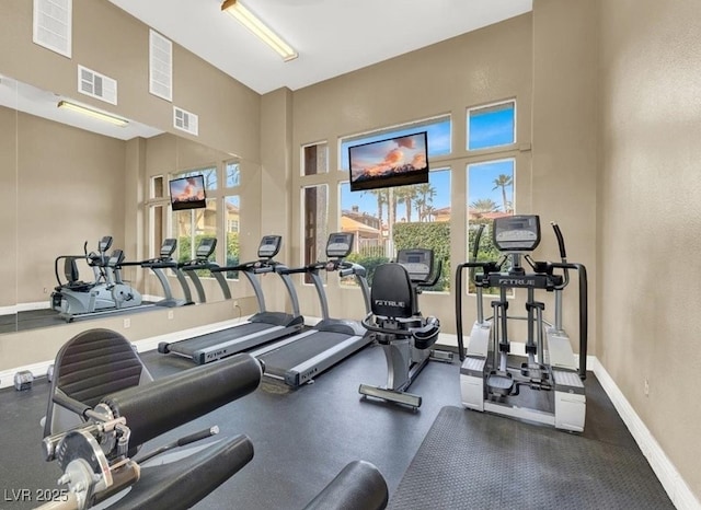 workout area with a high ceiling