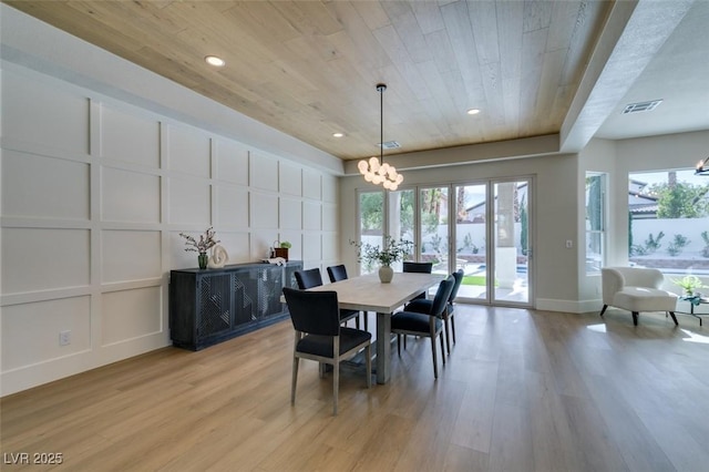 dining space with a chandelier, wooden ceiling, and light wood-type flooring