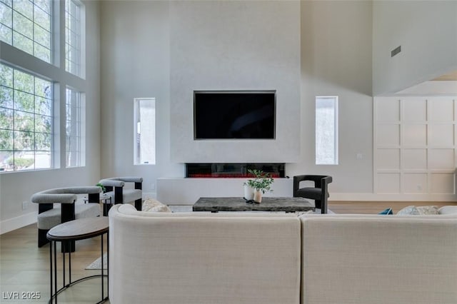 living room with hardwood / wood-style flooring and a high ceiling