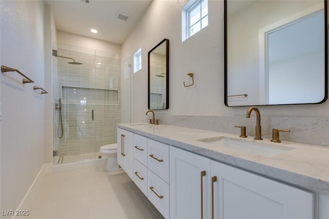 bathroom featuring vanity, a shower with shower door, tile patterned floors, and toilet