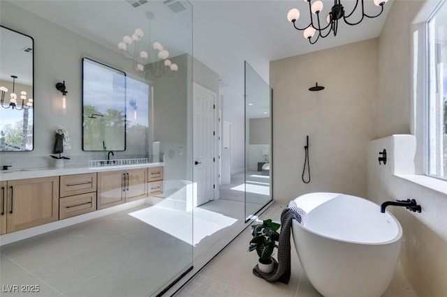 bathroom with independent shower and bath, vanity, a notable chandelier, and tile patterned floors