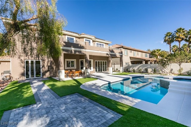 view of pool with a yard and a patio