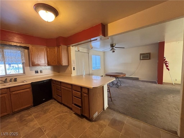 kitchen with sink, dishwasher, carpet flooring, a kitchen bar, and kitchen peninsula