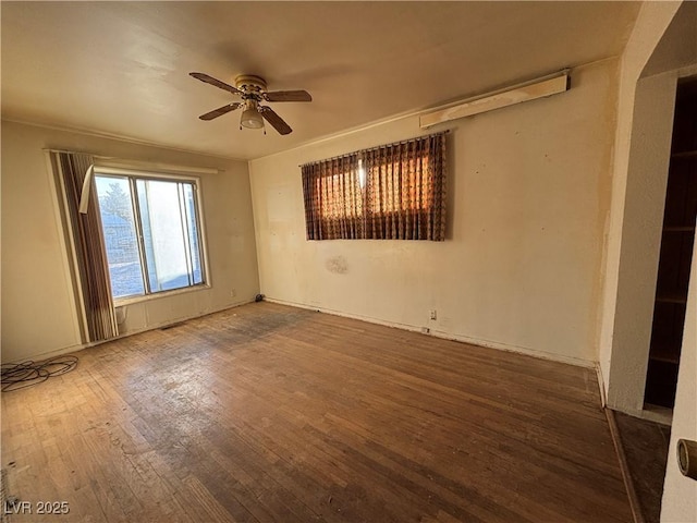 empty room with hardwood / wood-style floors and ceiling fan