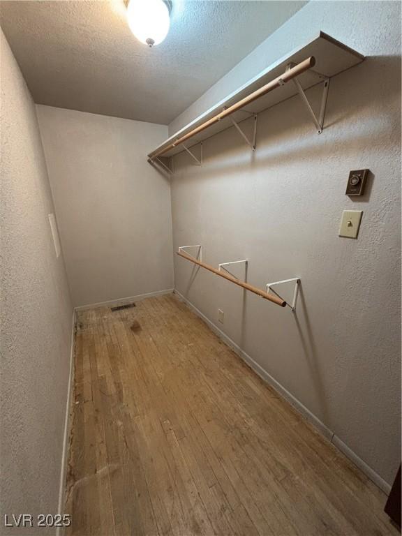 spacious closet featuring hardwood / wood-style floors