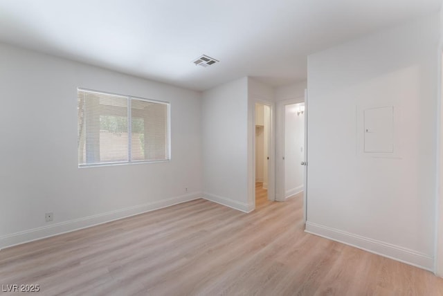 spare room featuring light hardwood / wood-style floors