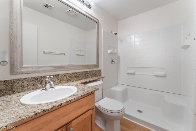 bathroom with vanity, toilet, and walk in shower