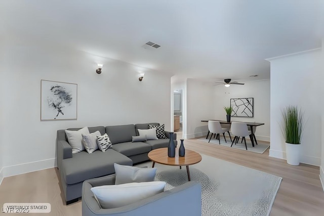 living room featuring ceiling fan and light wood-type flooring