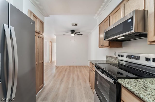 kitchen featuring crown molding, light wood-type flooring, ceiling fan, stainless steel appliances, and light stone countertops