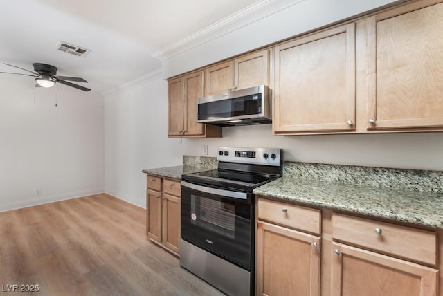 kitchen featuring crown molding, light stone counters, light hardwood / wood-style flooring, appliances with stainless steel finishes, and ceiling fan