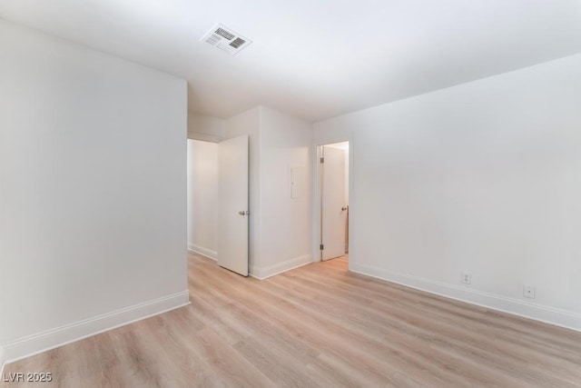 spare room with light hardwood / wood-style flooring