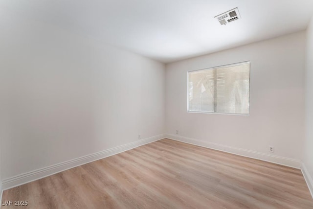 spare room featuring light wood-type flooring