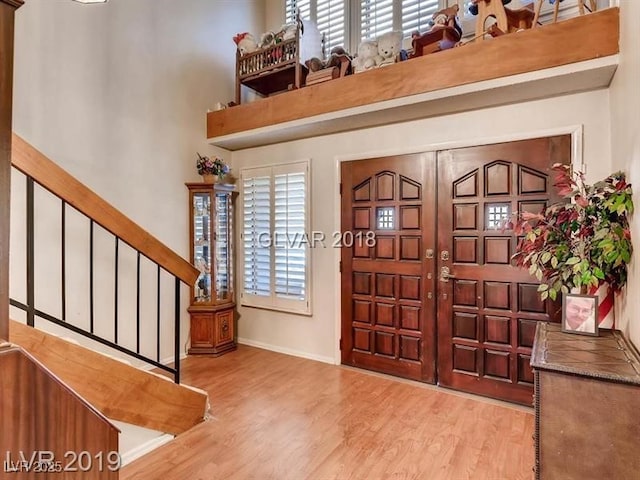 foyer featuring a wealth of natural light and light hardwood / wood-style floors