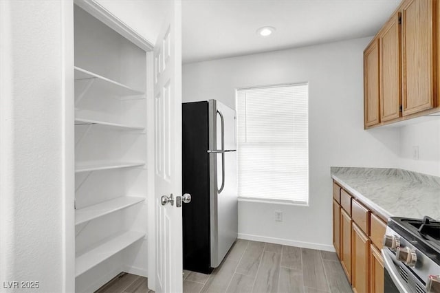 kitchen featuring light hardwood / wood-style flooring and appliances with stainless steel finishes