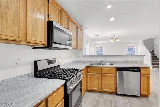 kitchen featuring appliances with stainless steel finishes, sink, and kitchen peninsula