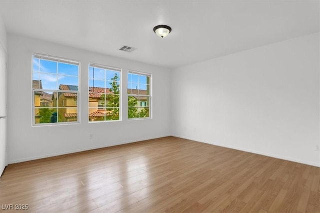 spare room with light hardwood / wood-style floors