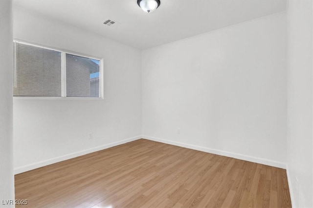 empty room with light hardwood / wood-style flooring