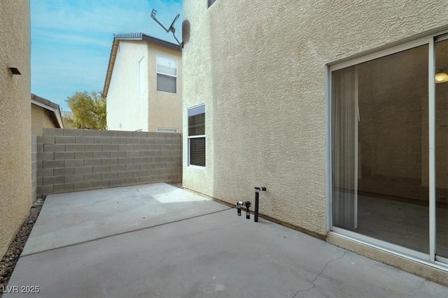 view of side of property featuring a patio area