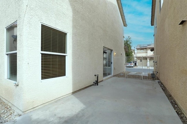 view of side of property with a patio