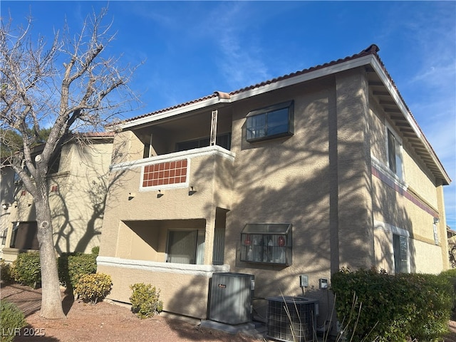 rear view of house featuring central AC