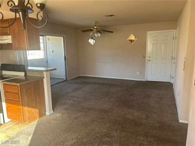 kitchen featuring electric range, ceiling fan, and dark colored carpet